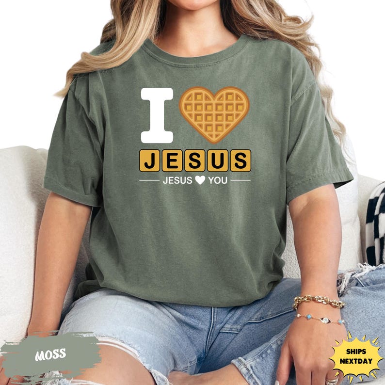A woman wearing a green t-shirt with a heart-shaped waffle and the text "I ♥ JESUS YOU" printed on it.
