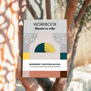 May include: A workbook titled "WORKBOOK Diseña tu vida" with a teal and yellow fan design. The cover also includes the text "NEURODISEÑO Y CREATIVIDAD APLICADA" and "1. Construcción del mapa sensorial personal". The book is set against a natural background.