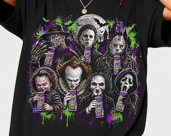 May include: A black t-shirt featuring a graphic print of six iconic horror movie characters, each holding a purple Alani Nu energy drink. The design includes splatters of bright green and purple paint, a full moon, and a dark castle silhouette.
