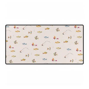 May include: Rectangular beige desk mat with a black border. The mat features a repeating pattern of colourful fish, fishing rods, and lures. The fish are in shades of yellow, orange, blue, and green. The fishing rods have white lines.