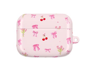 May include: A light pink AirPod case with a repeating pattern of pink bows, cherries, and tulips. The case has a smooth, glossy finish and a small loop for attaching a lanyard or keychain.
