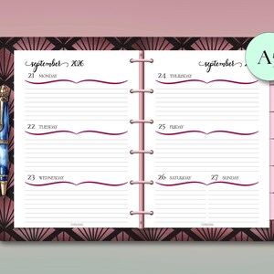 May include: A5 planner open to a September 2026 weekly spread. The pages are white with lined spaces for each day, and a decorative burgundy wave design. The cover has a geometric pattern in burgundy and black. A blue pen is visible.