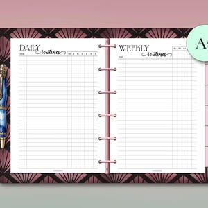 May include: An A5 planner open to show daily and weekly routine pages. The planner has a pink spine and a decorative cover with a geometric pattern in shades of brown and pink. A blue pen with gold accents is visible on the left side.
