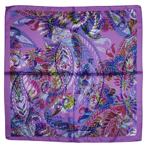 May include: A square, lavender-colored scarf with a detailed paisley pattern in shades of purple, blue, green, and red. The scarf has a solid lavender border and is likely made of silk or a similar fabric.