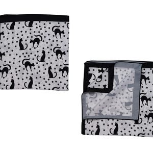May include: A white pocket square with a black border and a repeating pattern of black cat silhouettes and small black dots. One pocket square is folded, revealing the interior pattern.