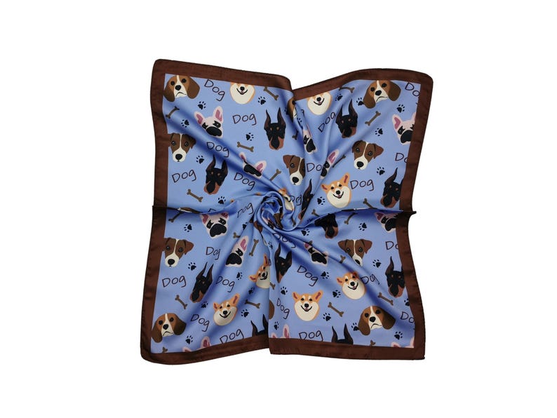 May include: A square, light blue scarf with a repeating pattern of various dog breeds, bones, and paw prints. The word "Dog" is also printed on the scarf. The scarf has a dark brown border.