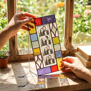 May include: A rectangular stained glass photo frame featuring a central vertical strip of four black and white portrait photos. The border is composed of multi-colored glass pieces in red, yellow, blue, purple, and pink with geometric patterns.
