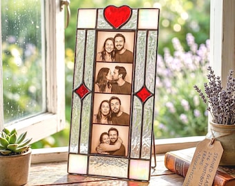 May include: A rectangular stained glass photo frame with a red heart at the top and red diamond accents. The frame holds four vertical photos of a couple. A tan tag attached to the frame reads: STAINED GLASS 2x6 PHOTOBOTH FRAME - MozeArtGlass.