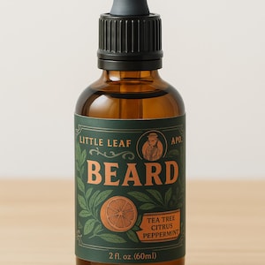 May include: A brown glass bottle of beard oil with a black dropper. The label is dark green with the words "LITTLE LEAF BEARD" and "TEA TREE CITRUS PEPPERMINT". The bottle contains 2 fl. oz. (60ml) of product.