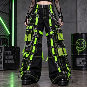 May include: Black cargo pants featuring neon green straps, multiple utility pockets with mesh detailing, silver metal chains, and D-ring hardware. The pants have neon green contrast stitching throughout and a black belt at the waist.