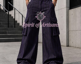 May include: Wide-leg cargo pants in a dark navy blue fabric with vertical purple pinstripes. The pants feature two large side cargo pockets with flaps, a button closure at the waist, and belt loops. The text Spirit of Artisans is visible.