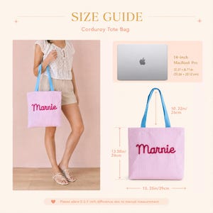 May include: A light pink corduroy tote bag with blue handles and the name Marnie embroidered in dark pink script. The bag measures 13.38 inches by 15.35 inches with a 10.23 inch handle drop, shown alongside a 14-inch MacBook Pro for scale.