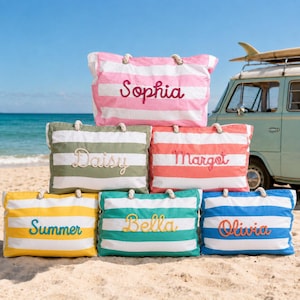 May include: Six rectangular canvas tote bags with horizontal stripes in pink, olive green, coral, yellow, teal, and blue. Each bag features rope handles and a name embroidered in cursive script: Sophia, Daisy, Margot, Summer, Bella, and Olivia.