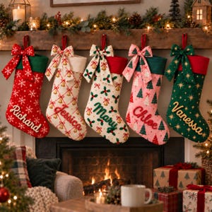 May include: Five personalized Christmas stockings hanging in a row. From left to right: a red stocking with white snowflakes and the name Richard, a cream stocking with gold bells and the name Jessica, a cream stocking with holly and the name Mary, a pink stocking with green trees and the name Chloe, and a green stocking with gold stars and the name Vanessa.