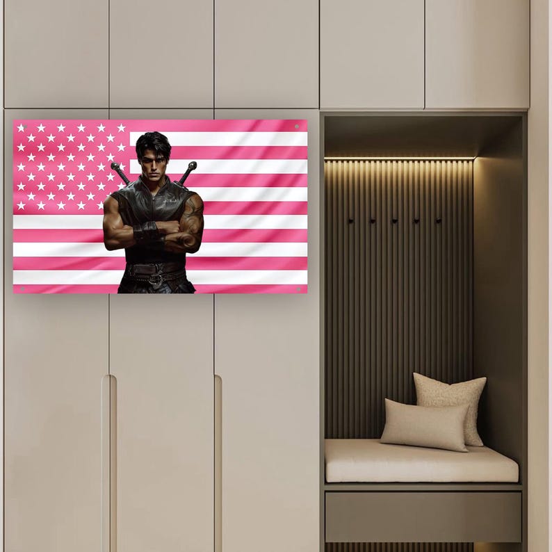 May include: A canvas print featuring a muscular figure with crossed arms, two swords, and a pink and white American flag background. The artwork is displayed on a wall in a neutral-toned room.