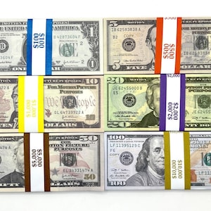 May include: Six stacks of prop money labeled for motion picture purposes, including one-dollar, five-dollar, ten-dollar, twenty-dollar, fifty-dollar, and one-hundred-dollar bills, each secured with a colored paper currency strap indicating the total value.