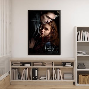 Op de afbeelding: Een ingelijste filmposter voor "Twilight" met twee mensen in een innige omhelzing. De poster heeft een donkere achtergrond met de titel "twilight" in witte tekst. De releasedatum is ook zichtbaar.
