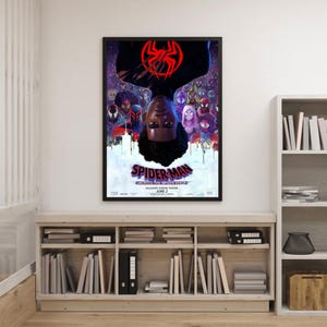 May include: Framed movie poster for "Spider-Man: Across the Spider-Verse" featuring Miles Morales. The poster has a black frame and shows the character upside down with a red spider symbol. The background is a colorful collage of other Spider-Man characters.