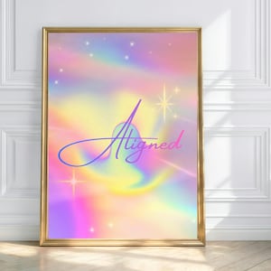 May include: A rectangular wall art print in a gold frame featuring a holographic, iridescent background with swirling pastel colours of pink, yellow, and blue. The word Aligned is written in a purple cursive script, accented by small white stars.