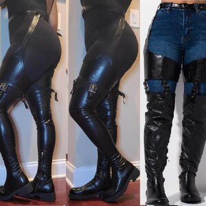May include: Black thigh-high boots with buckles and zips. The boots are made of a shiny material and have a platform sole. The boots are worn with black leggings and blue jeans.