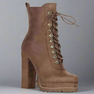 May include: A brown suede-like ankle boot with a platform sole and a chunky high heel. The boot features a lace-up design with metal eyelets and a pull tab at the back. The heel height is approximately 5 inches.
