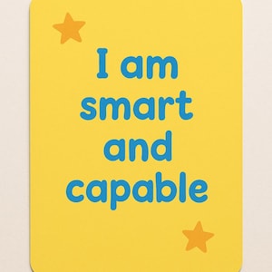 May include: A yellow rectangular card with rounded corners features the text "I am smart and capable" in blue. Two orange stars are placed at the top left and bottom right corners of the card.