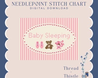 May include: Needlepoint stitch chart digital download with a pink and white striped background. The design features the words "Baby Sleeping" with images of baby shoes, a teddy bear, and flowers. The design is framed by a scalloped edge.