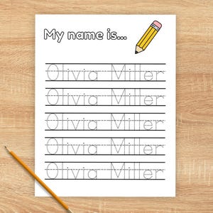 May include: A white sheet with the text "My name is..." and the name "Olivia Miller" repeated for tracing practice. A yellow pencil with a pink eraser is in the upper right corner. The words "PERSONALIZED NAME TRACING" are at the bottom.