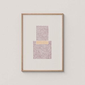 May include: Framed abstract art print featuring a geometric design. The artwork showcases a rectangular shape with a smaller rectangle on top, connected by a horizontal band. The design is in shades of purple and gold, set against a white background.