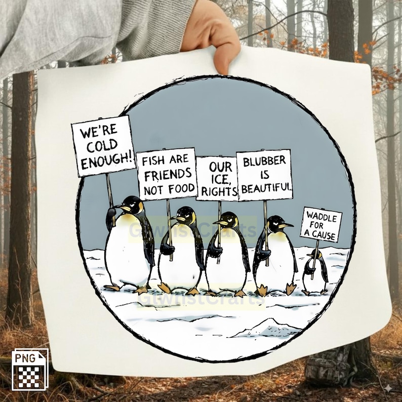 May include: A cartoon illustration of penguins holding signs with messages like "We're Cold Enough!" and "Fish Are Friends Not Food." The penguins are in a snowy environment, advocating for their rights. The image is held by a person.