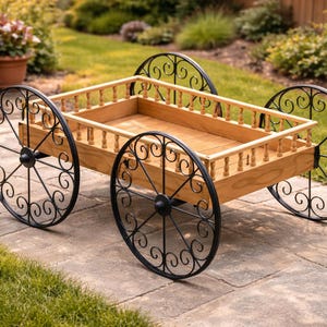 May include: A wooden garden cart with a rectangular bed and decorative black metal wheels. The cart features a light brown wooden bed with a railing and is designed for outdoor use.