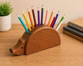 May include: A wooden hedgehog-shaped pencil holder with a smooth brown finish, featuring a series of holes along the curved back. Eleven colored pencils in shades of blue, yellow, orange, brown, purple, black, pink, tan, red, and green are inserted.