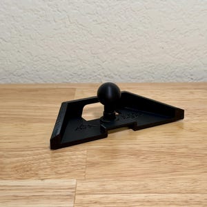 May include: A white ceramic mug with a black handle and the text "But First, Coffee" in a black, bold font. The mug is sitting on a wooden surface. The mug is approximately 4 inches tall.