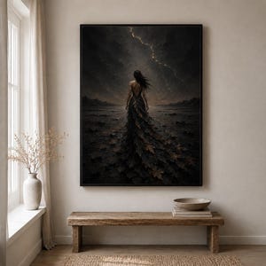 May include: A framed wall art print depicting a figure standing in a dark, desolate landscape under a stormy sky with a single bolt of lightning. The figure wears a long, flowing gown made of dark, textured leaves that blend into the terrain.