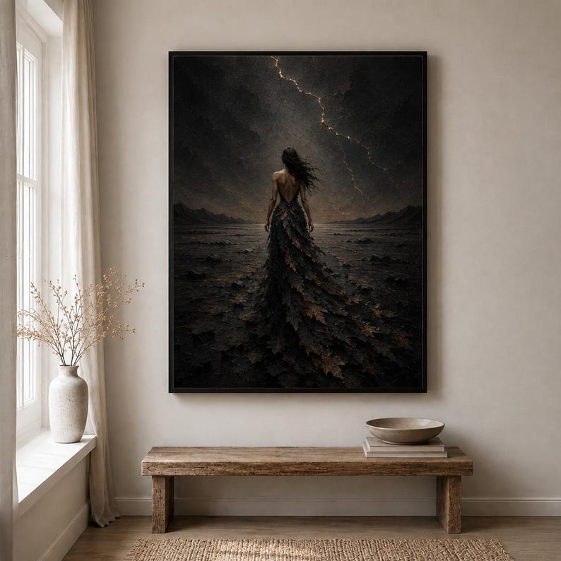 May include: A framed wall art print depicting a figure standing in a dark, desolate landscape under a stormy sky with a single bolt of lightning. The figure wears a long, flowing gown made of dark, textured leaves that blend into the terrain.