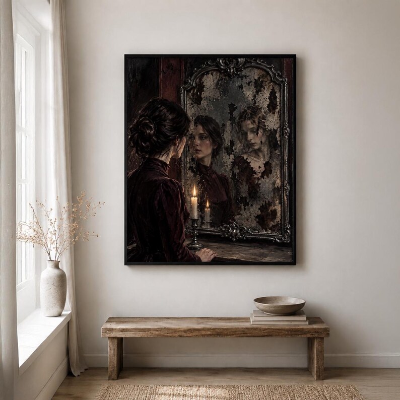 May include: A framed wall art print depicting a person with dark hair in a dark red garment standing before an ornate, weathered mirror. A lit candle sits on a surface in front of the mirror, casting a warm glow on the person and their reflection.