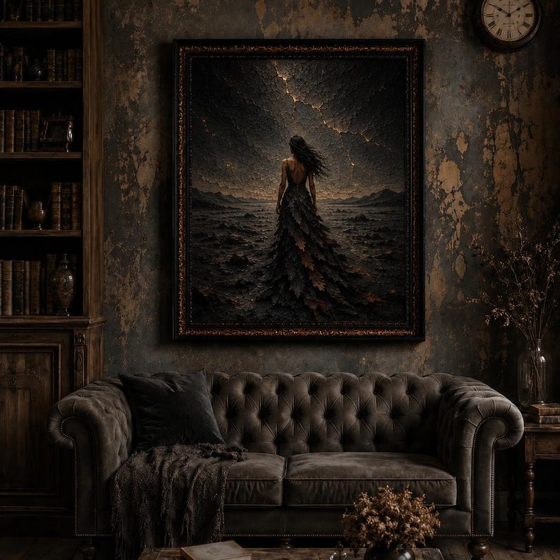 May include: A framed wall art print depicting a figure in a long, dark, textured gown standing in a desolate, rocky landscape under a stormy, cracked sky with golden light, displayed in a room with a tufted sofa and a wooden bookshelf.