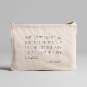 May include: A cream-colored zippered pouch with the quote "Sometimes we only see how people are different from us. But if you look hard enough, you can see how much we're all alike." - Jasmine, Aladdin.