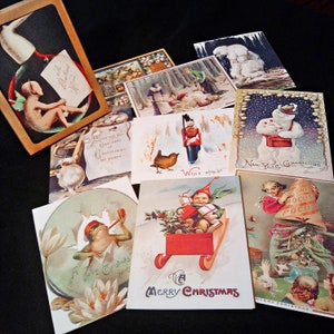 May include: A collection of vintage Christmas and New Year's greeting cards featuring various illustrations, including a snowman, a toy soldier, a frog, and a bird. The cards are decorated with festive colours and designs.