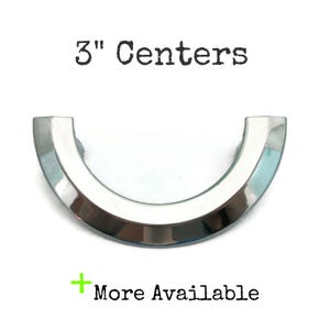 May include: A silver, 3-inch center, arched cabinet pull.  "3" Centers"