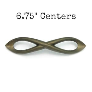 May include: Bronze-colored cabinet pull with an infinity symbol design. The pull measures 6.75 inches between centers. The hardware has a smooth, curved shape and is set against a white background.