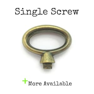 May include: An antique brass-colored single screw with an oval handle and a square base. The text "Single Screw" is above the screw, and "More Available" is below it.
