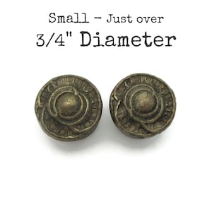 May include: Two antique bronze-colored buttons with an ornate circular design. The buttons are approximately 0.75 inches in diameter. Text above the buttons reads "Small - Just over 3/4" Diameter."