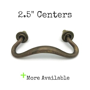 May include: A white ceramic mug with a black handle and the text "But First, Coffee" in a handwritten style. The mug is on a white surface. The mug is approximately 4 inches tall.