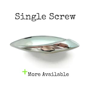 May include: A single, silver-toned screw with a reflective, oval design. The text "Single Screw" is above the screw, and "More Available" is below it.