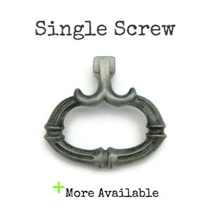 May include: A single, ornate, gray-toned screw with a decorative handle. The handle has a curved, oval shape with detailed molding. The text "Single Screw" is above the screw, and "More Available" is below.