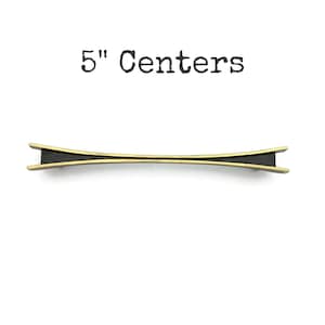 May include: A handmade wooden sign with the text "Welcome to our home" in a handwritten style. The sign is painted white with a distressed finish and a dark brown border. A small, decorative heart is attached to the bottom.