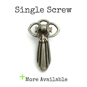 May include: A single, antique-style silver drawer pull with a decorative design. The pull has a teardrop shape with vertical lines and a floral-inspired top. Text above reads "Single Screw" and below "More Available".