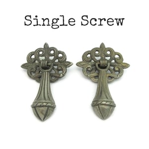 May include: A set of three ceramic vases in varying heights and shapes. The vases are glazed in a matte white finish, offering a minimalist aesthetic. The tallest vase is approximately 10 inches high.