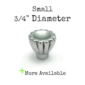 May include: A small, silver, decorative knob with a fluted design. The knob is 3/4 inch in diameter.  Small Diameter